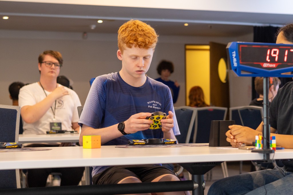 Henry Eyles solving a clock at Nationals 2024